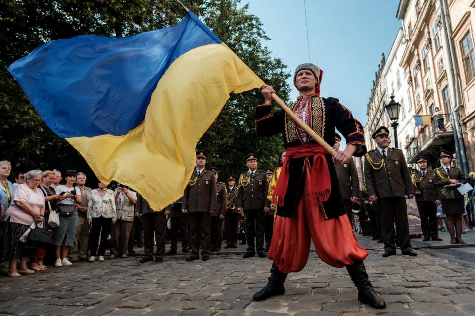 A man in Ukrainian traditional cossack clothes holds the Ukrainian flag during the anniversary of the proclamation of the Act of Ukrainian State on June 30, 2023 in Lviv, Ukraine. On June 30, 1941 during WWII, Yaroslav Stetsko declared an independent Ukrainian State in Lviv from the balcony of the “Prosvita” (“Education”) society. (Les Kasyanov/Global Images Ukraine via Getty Images)