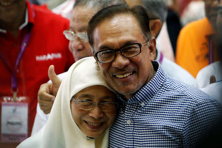 Malaysia's politician Anwar Ibrahim celebrates with his wife Wan Azizah after winning the by-election in Port Dickson, Malaysia October 13, 2018. REUTERS/Lai Seng Sin