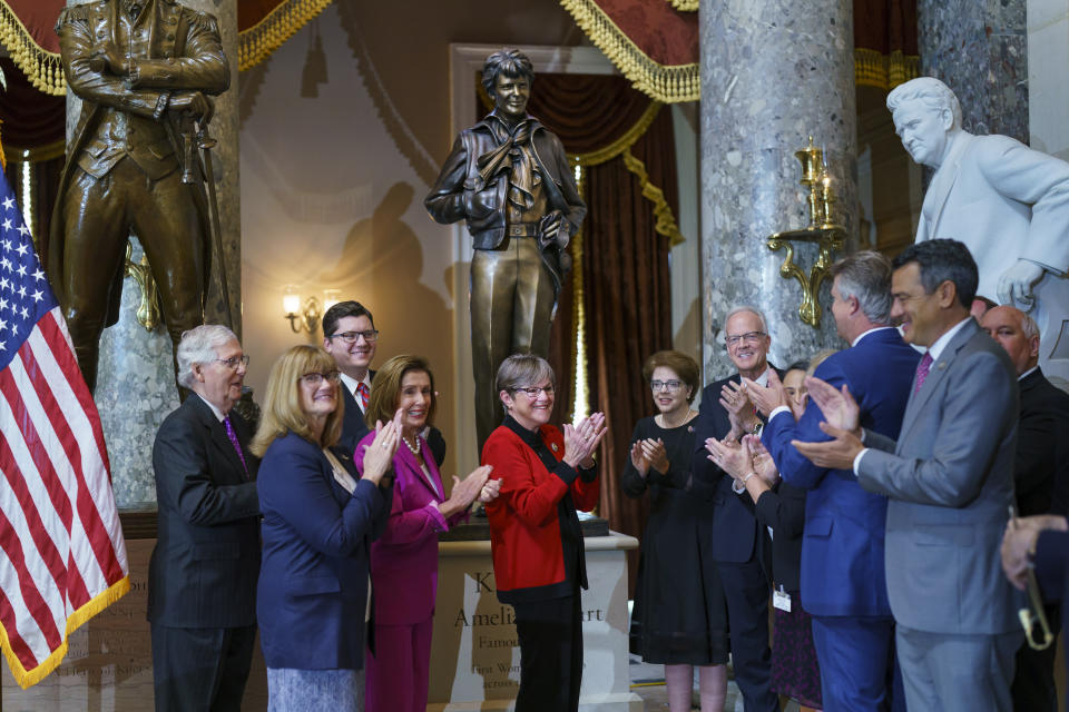 Kansas Governor Laura Kelly, center, is joined by Speaker Nancy Pelosi, D-Calif., center left, Senate Minority Leader Mitch McConnell, R-Ky., far left, former Kansas Sen. Jerry Moran, center right, for the dedication and unveiling ceremony of a statue of in honor of Amelia Earhart, one of the world's most celebrated aviators and the first woman to fly solo across the Atlantic Ocean, in Statuary Hall, at the Capitol in Washington, Wednesday, July 27, 2022. The statue of Amelia Earhart will represent the State of Kansas in the National Statuary Hall Collection. (AP Photo/J. Scott Applewhite)