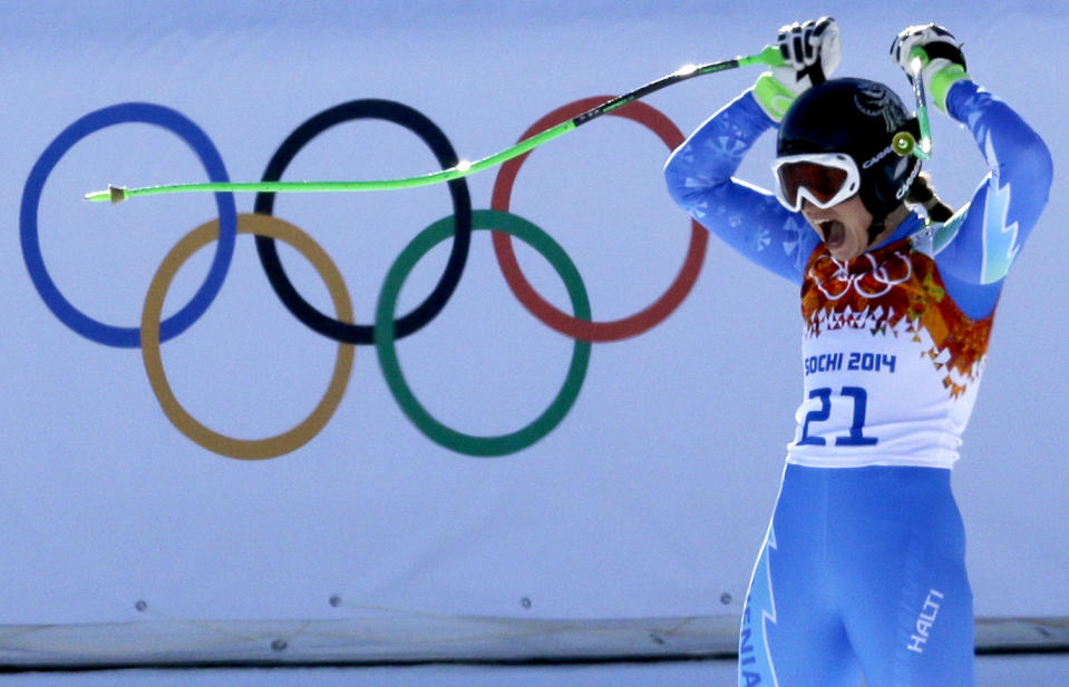 Slovenia's Tina Maze celebrates after finishing the women's downhill, to tie for first place with Switzerland's Dominique Gisin at the Sochi 2014 Winter Olympics, Wednesday, Feb. 12, 2014, in Krasnaya Polyana, Russia. (AP Photo/Kirsty Wigglesworth)