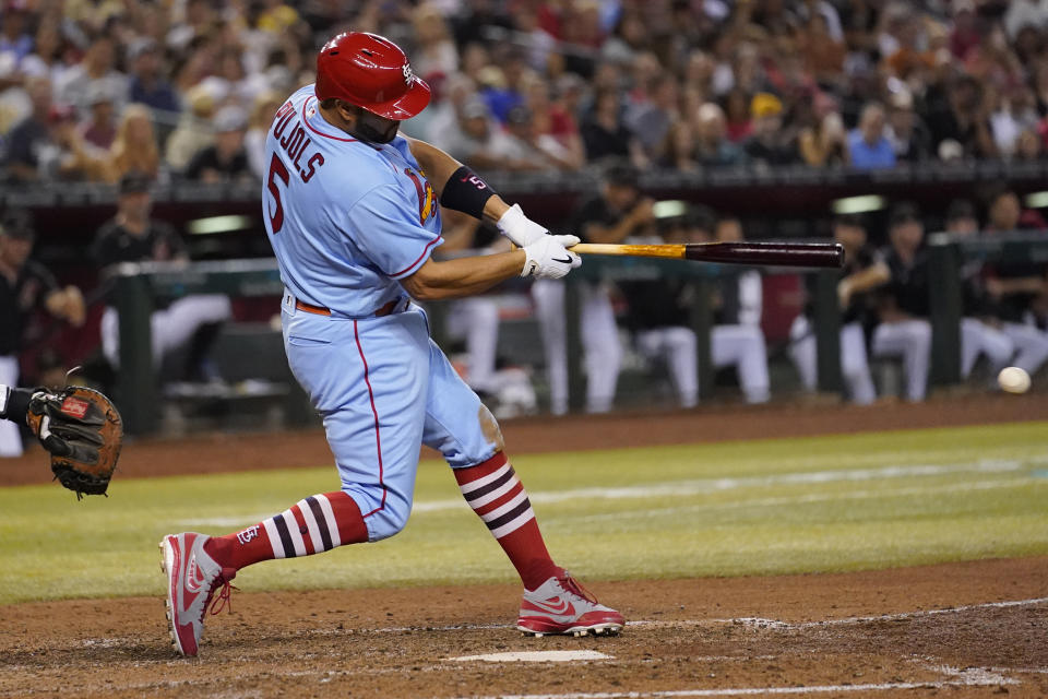 St. Louis Cardinals' Albert Pujols connects for a base hit against the Arizona Diamondbacks during the seventh inning of a baseball game, Saturday, Aug. 20, 2022, in Phoenix. (AP Photo/Matt York)