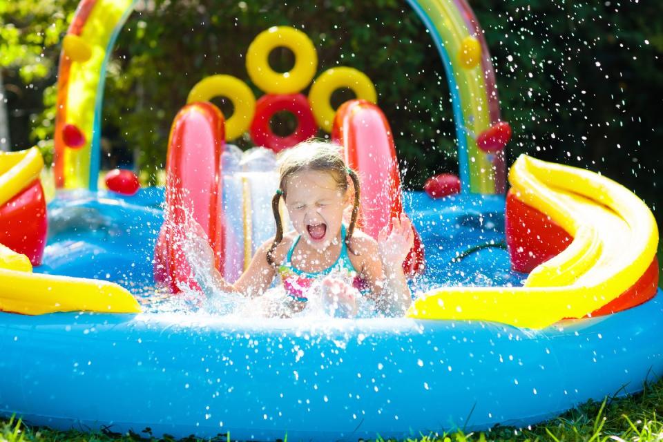 child playing in inflatable kid's pool