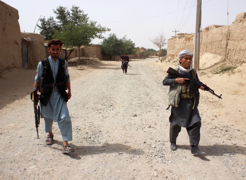 Armed Afghan militias patrol on the outskirts of Takhar province