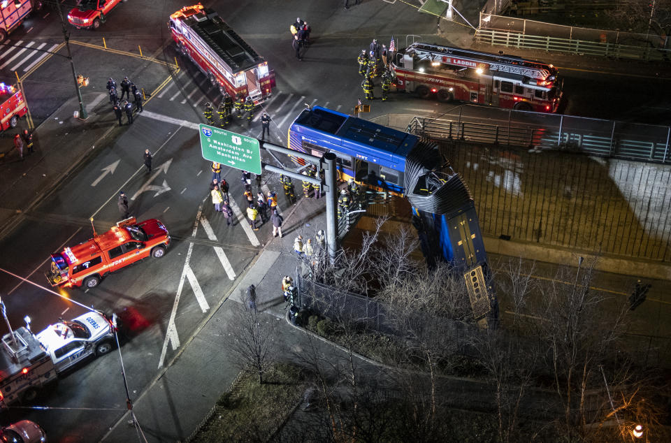 A bus in New York City which careened off a road in the Bronx neighborhood of New York is seen left dangling from an overpass Friday, Jan. 15, 2021, after a crash late Thursday that left the driver in serious condition, police said. (AP Photo/Craig Ruttle)