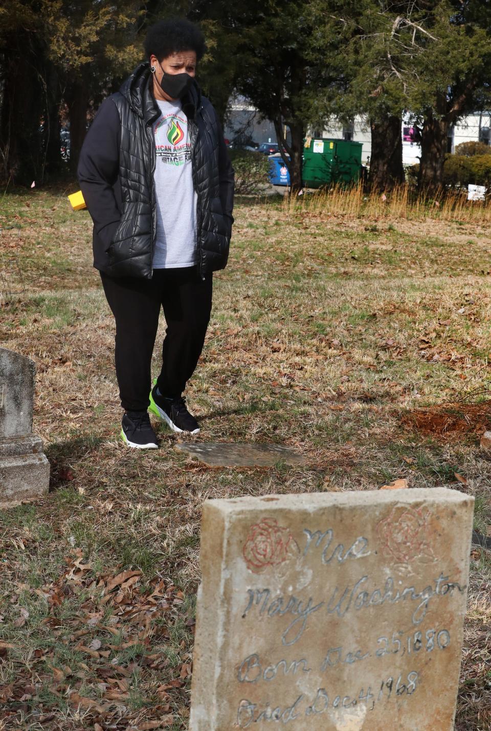 President Mary Watkins of the African American Heritage Society of Rutherford County explores the Benevolent Cemetery in Murfreesboro, Tenn., on Tuesday, Jan. 25, 2022.