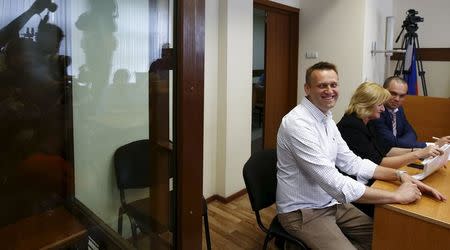 Russian opposition leader Alexei Navalny smiles before a hearing at the Lublinsky district court in Moscow, Russia, May 13, 2015. REUTERS/Maxim Zmeyev