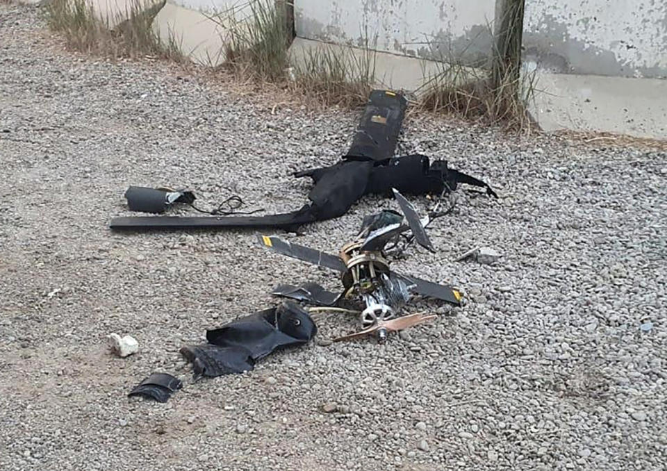 Parts of the wreckage of a drone lie on the ground at Baghdad airport, Iraq, Monday, Jan. 3, 2022. Two armed drones were shot down at the Baghdad airport on Monday, a U.S.-led coalition official said, an attack that coincides with the anniversary of the 2020 U.S. killing of a top Iranian general. (International Coalition via AP)