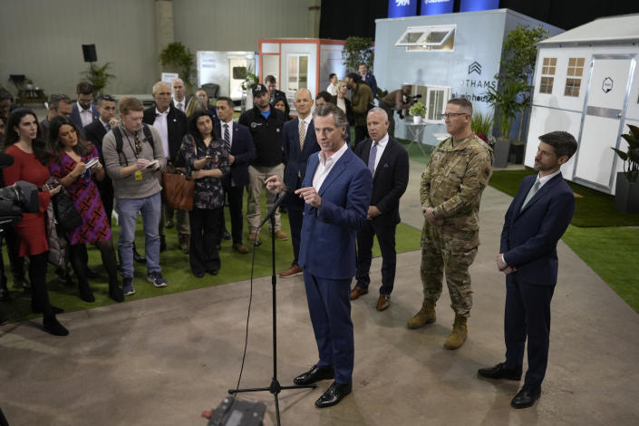 California Gov. Gavin Newsom talks to reporters after announcing his plans to build 1,200 small homes across the state to reduce homelessness, during the first of a four-day tour of the state in Sacramento Calif., on Thursday, March 16, 2023. (AP Photo/Rich Pedroncelli)