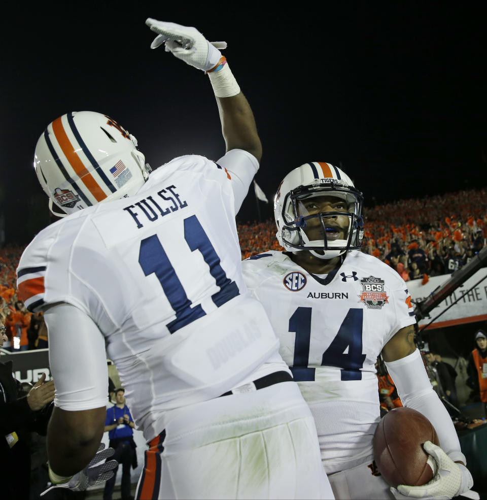 Auburn's Nick Marshall celebrates his touchdown run with Brandon Fulse during the first half of the NCAA BCS National Championship college football game against Florida State Monday, Jan. 6, 2014, in Pasadena, Calif. (AP Photo/David J. Phillip)