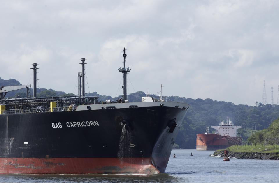 Cargo ships navigate through Panama Canal waters in Gamboa, Panama, Wednesday, June 17, 2020. The Panama Canal began to feel the first adverse effects of the coronavirus pandemic on its business after registering a drop in its ship transits while applying rigorous measures to prevent further contagion among its workers. (AP Photo/Arnulfo Franco)