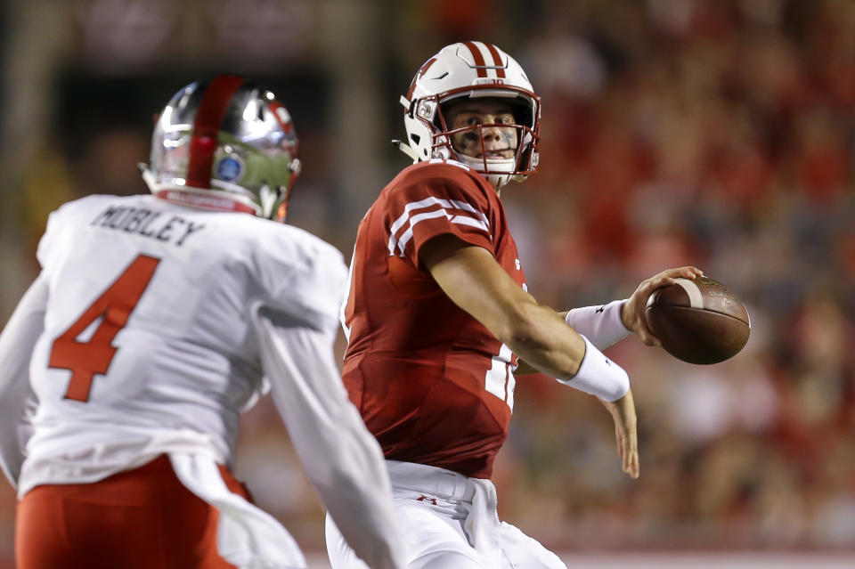 Wisconsin quarterback Alex Hornibrook looks to pass the ball as Western Kentucky linebacker Der'Quione Mobley watches during the first half of an NCAA college football game Friday, Aug. 31, 2018, in Madison, Wis. (AP Photo/Andy Manis)