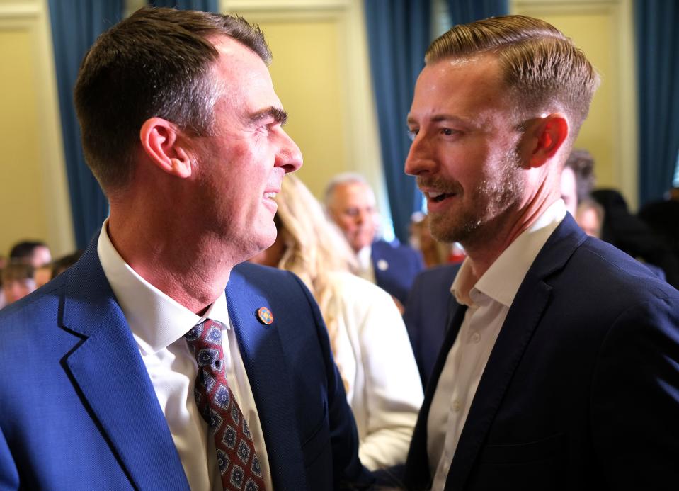 Gov. Kevin Stitt speaks with state schools Superintendent Ryan Walters at a May 25 education bill signing in the state Capitol Blue Room. Walters was Stitt's education secretary from 2020 until April, when the governor appointed Oklahoma State University professor Katherine Curry. Curry resigned from the post on Tuesday.