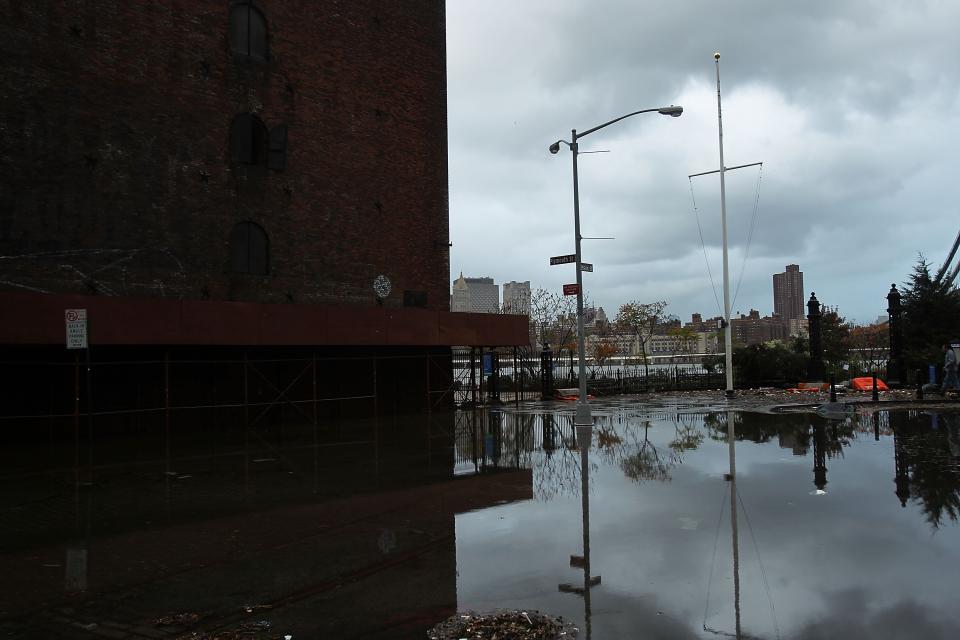 NEW YORK, NY - OCTOBER 30: A flooded street in the Dumbo section of Brooklyn is viewed after the city awakens to the affects of Hurricane Sandy on October 30, 2012 in New York, United States. At least 15 people were reported killed in the United States by Sandy as millions of people in the eastern United States have awoken to widespread power outages, flooded homes and downed trees. New York City was his especially hard with wide spread power outages and significant flooding in parts of the city. (Photo by Spencer Platt/Getty Images)