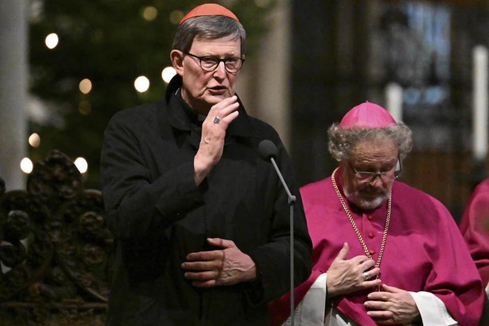 Cardinal Rainer Maria Woelki, front, gestures during the funeral prayer for Pope Emeritus Benedict XVI in Cologne Cathedral, in Cologne, Germany, Saturday, Dec. 31, 2022. Pope Emeritus Benedict XVI, the German theologian who will be remembered as the first pope in 600 years to resign, has died, the Vatican announced Saturday. He was 95. (Federico Gambarini/dpa via AP)