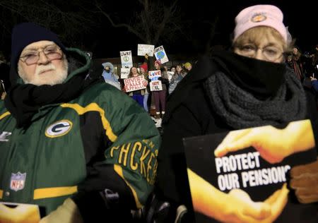 Unions workers (front) and various supporters hold up signs before a U.S. Democratic presidential candidates debate in Milwaukee, Wisconsin, United States February 11, 2016. REUTERS/Darren Hauck