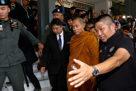 Phra Buddha Issara, 62, an activist monk, is escorted by police officers at the Thai Police Crime Suppression Division headquarters in Bangkok, Thailand, May 24, 2018. REUTERS/Stringer NO RESALES. NO ARCHIVES