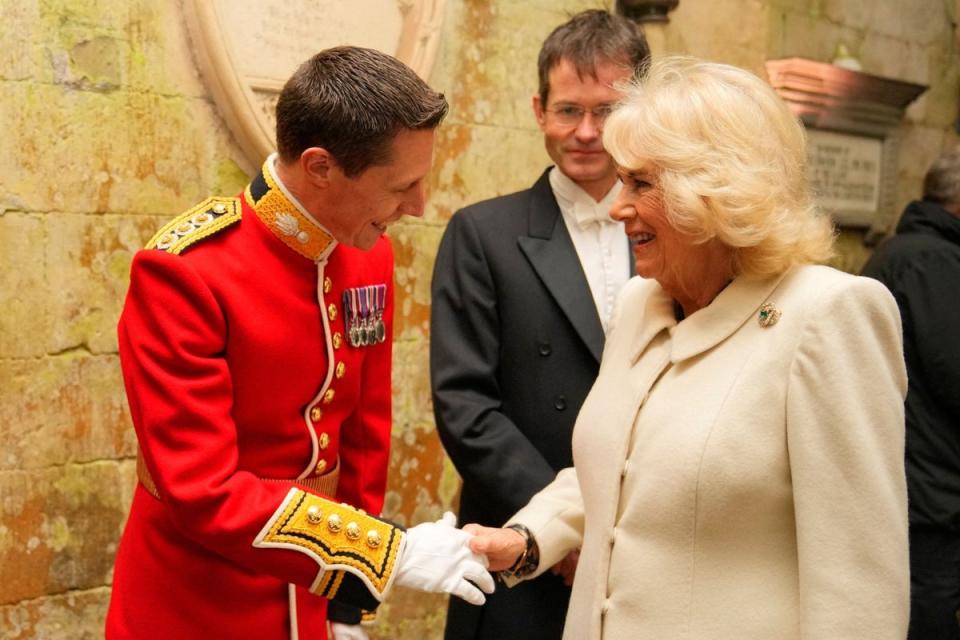 Camilla shakes hands with Captain Robert Smith Director of Music the Grenadier Guards Band (via REUTERS)