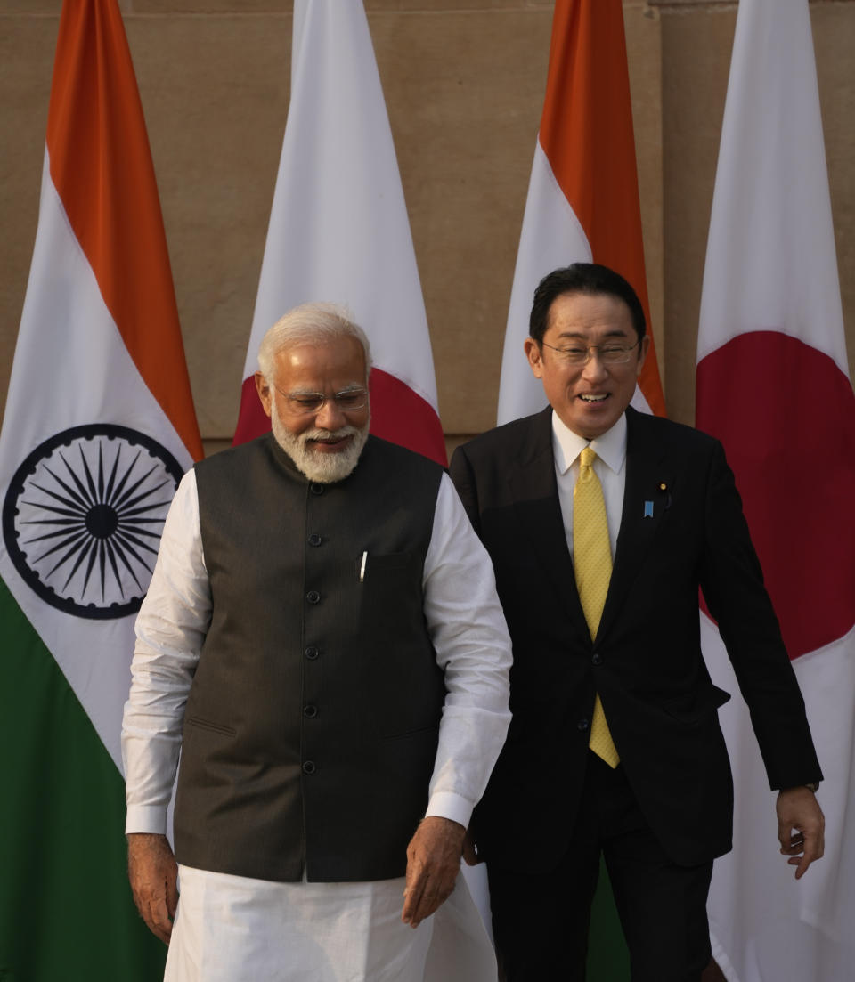 Indian Prime Minister Narendra Modi walks with his Japanese counterpart Fumio Kishida in New Delhi, Saturday, March 19, 2022. Kishida is meeting with Modi to strengthen their partnership in the Indo-Pacific and beyond in view of China’s growing footprint in the region, an Indian official said Thursday. (AP Photo/Manish Swarup)