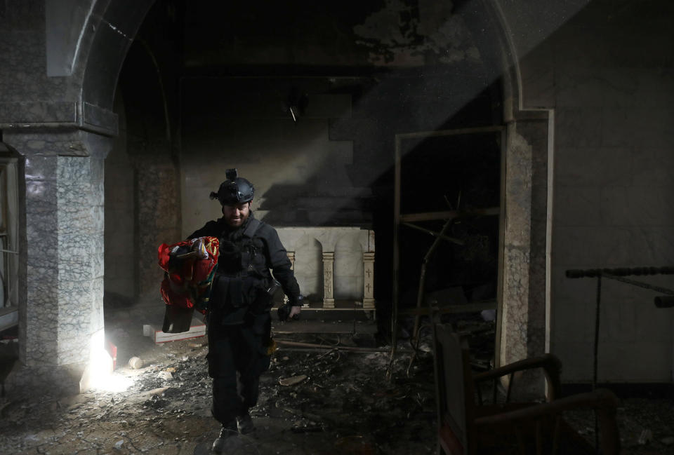 Special forces soldier walks in a church in Bartella