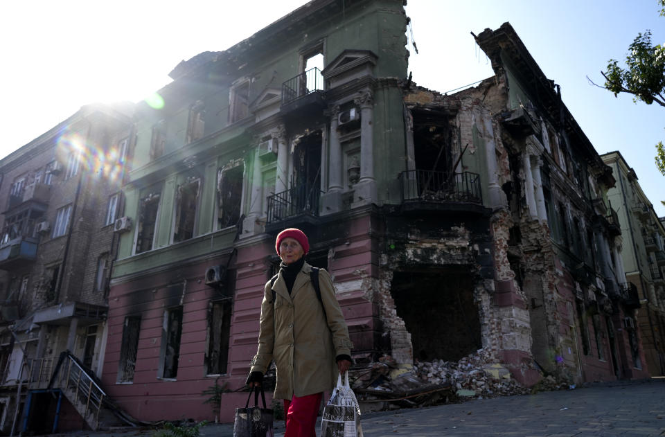 A woman walks past the damaged area after clashes are occurred as Russia-Ukraine war continues in Mariupol, Donetsk Oblast, Ukraine on September 29, 2022.