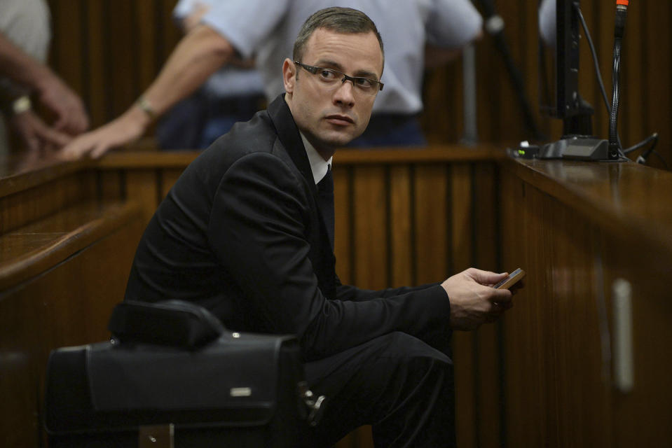 Oscar Pistorius sits in the dock during his murder trial at a court in Pretoria, South Africa, Friday, March 14, 2014. Pistorius is charged with the shooting death of his girlfriend Reeva Steenkamp, on Valentines Day in 2013. (AP Photo/Phill Magakoe, Pool)