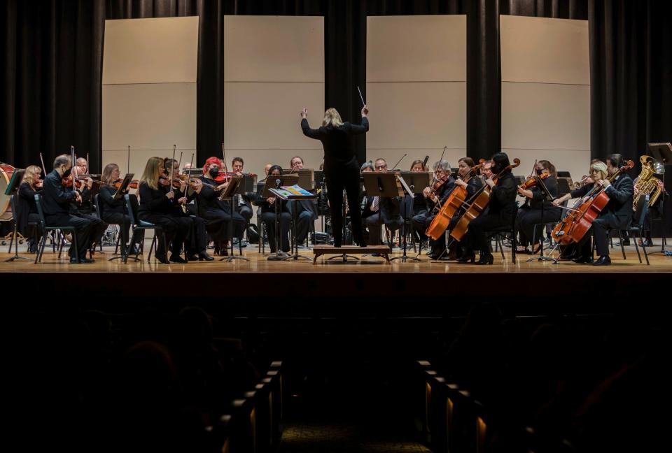 Music Director & Conductor of the Warren Symphony Orchestra, Gina Provenzano, leads the orchestra in front of middle school and elementary students inside the Warren Woods Community Auditorium at Warren Woods Middle School in Warren on Oct. 27, 2022. 