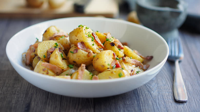 German potato salad with red onion and bacon bits and chives