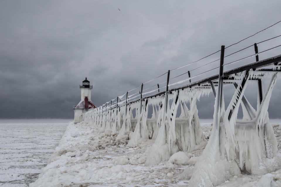 SOUTH HAVEN, MI - JANUARY 8: St Joseph's Lighthouse and the ice-covered pier, on January 8, 2015, in South Haven, Michigan.ICE engulfs a red lighthouse as a fierce winter storm grips South Haven, Michigan. Sharp icicles and surreal formations can be seen hanging from the railings after strong waves crashed onto the piers. After each coating the water quickly freezes to ice and the pier is transformed into a slippery, white wonderland. Weather in the area dipped into the minus figures and froze over Lake Michigan in the beginning of January.PHOTOGRAPH BY Mike Kline / Barcroft MediaUK Office, London.T +44 845 370 2233W www.barcroftmedia.comUSA Office, New York City.T +1 212 796 2458W www.barcroftusa.comIndian Office, Delhi.T +91 11 4053 2429W www.barcroftindia.com