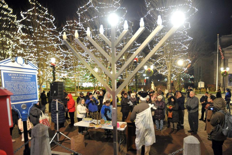 A menorah is lit at the Hancock Adams Common in Quincy during a ceremony on the first night of Hanukkah, Sunday, Dec. 18, 2022.