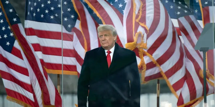 Trump in front of US flags on January 6