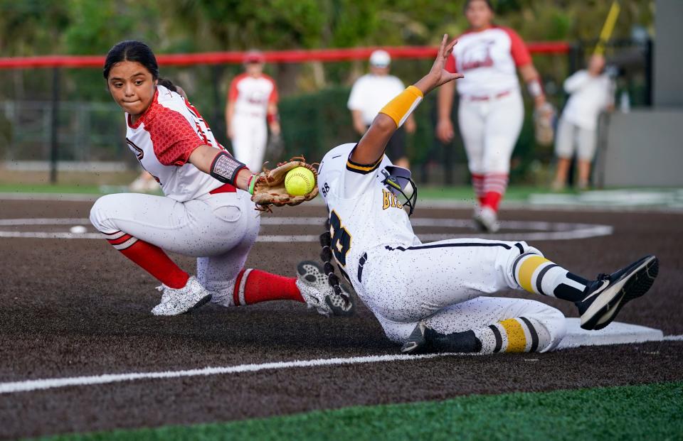 Evangelical Christian School Sentinels infielder Samantha Yzaguirre (11) tries to apply a tag to Bishop Verot Vikings baserunner Jaelyn Riley (88) during the sixth inning of the Private 8 tournament final at Evangelical Christian School in Fort Myers on Thursday, March 9, 2023.