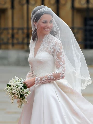 <p>Pascal Le Segretain/Getty</p> Kate Middleton holding her wedding bouquet