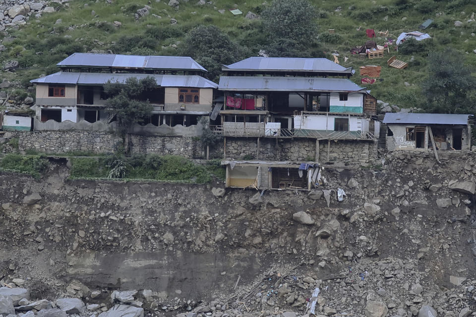 Homes destroyed by floodwaters hang to a cliff in the Kalam Valley in northern Pakistan, Tuesday, Aug. 30, 2022. Officials in Pakistan raised concerns Wednesday over the spread of waterborne diseases among thousands of flood victims as flood waters from powerful monsoon rains began to recede in many parts of the country. (AP Photo/Sherin Zada)