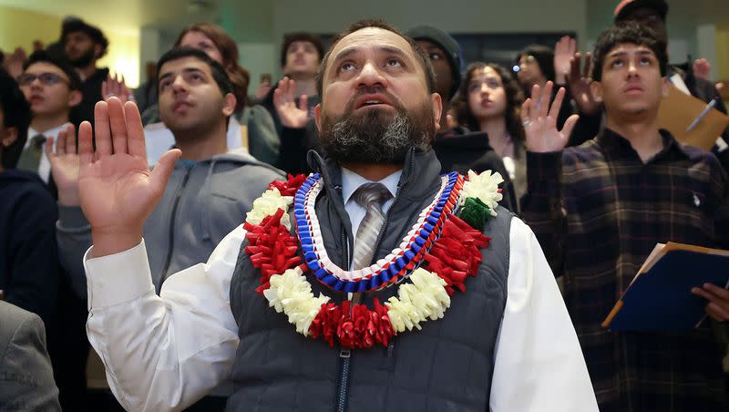 Himinai Tausinga, from Tonga, takes the naturalization oath of allegiance to the United States of America during a naturalization ceremony at the Salt Lake City Public Library in Salt Lake City on Wednesday, Feb. 14, 2024.