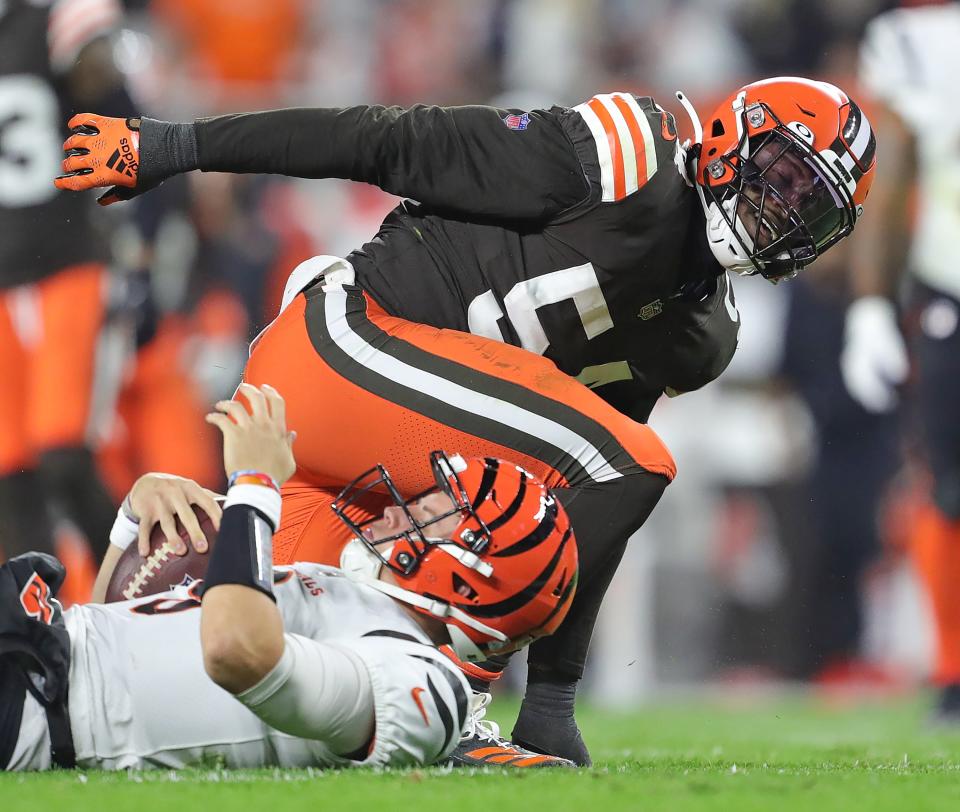 Browns linebacker Deion Jones celebrates as he gets up after sacking Bengals quarterback Joe Burrow during the second half Monday, Oct. 31, 2022, in Cleveland.