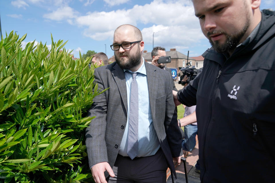 Paul Crowther, (centre) who threw milkshake over Nigel Farage, is ushered away as he leaves North Tyneside Magistrates' Court in North Shields where he has been ordered to pay the Brexit Party leader compensation following the "politically motivated" attack.