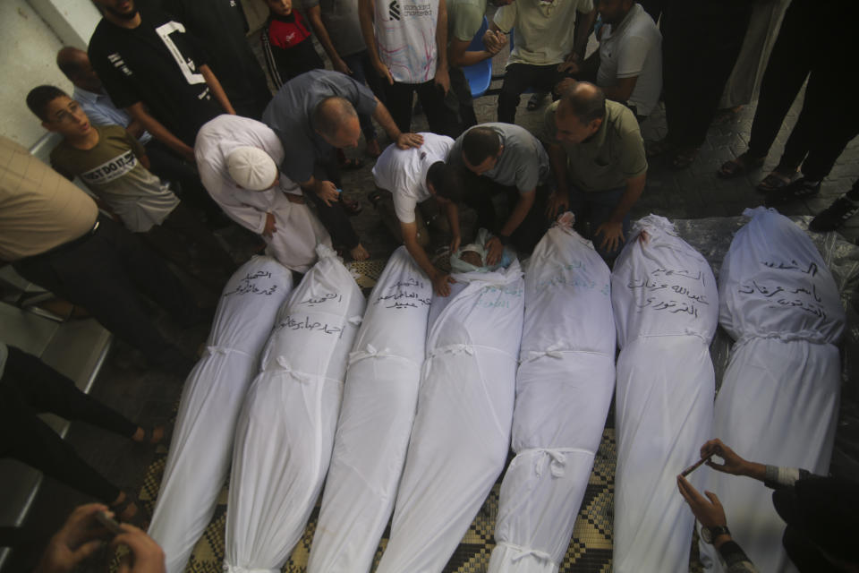 Palestinians mourn over the bodies of the people killed in the Israeli bombing in Rafah, Gaza Strip, Monday, Oct. 16, 2023. (AP Photo/Hatem Ali)