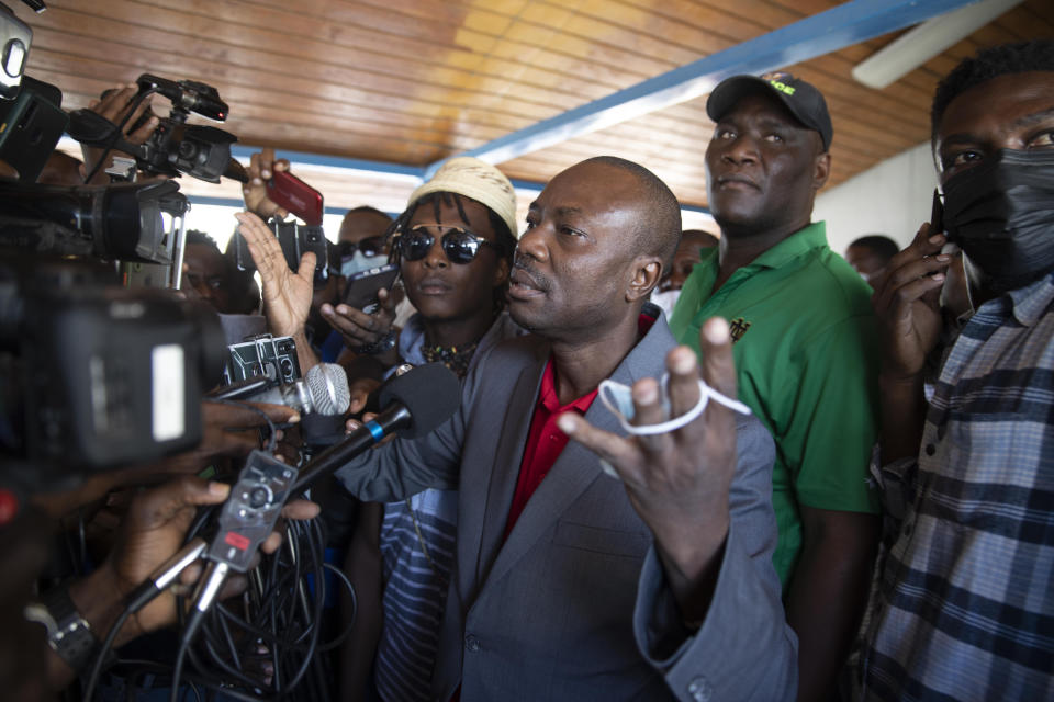 Former Haitian senator and presidential candidate Moise Jean-Charles speaks to the press at the Toussaint Louverture International Airport in Port-au-Prince, Haiti, Tuesday, Jan. 25, 2022. Jean-Charles said he was arrested in the U.S. and deported to Haiti but it wasn’t clear why he was deported or whether he faces any charges. (AP Photo/Odelyn Joseph)