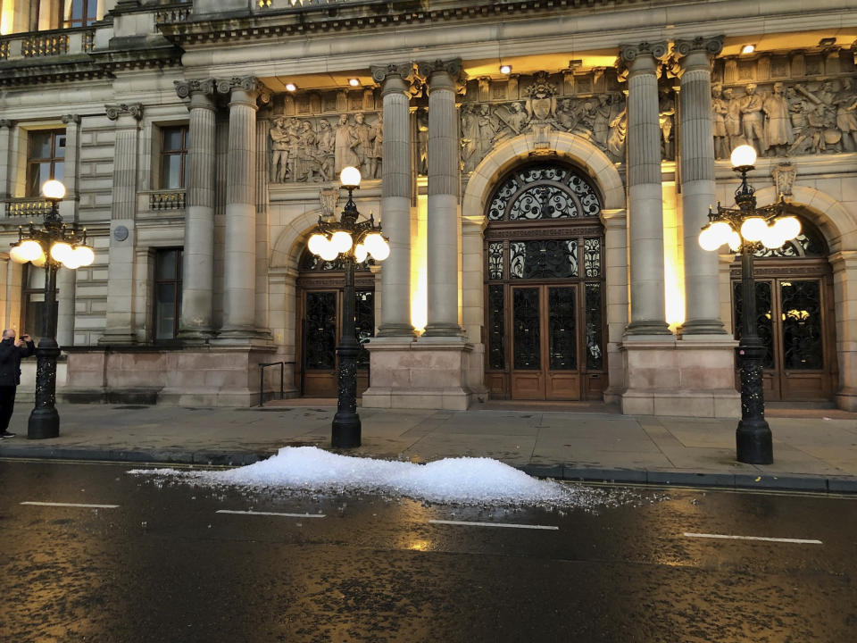 Left over ice dumped on the street in Glasgow in a protest by hospitality workers, as temporary restrictions announced by First Minister Nicola Sturgeon to help curb the spread of coronavirus have come into effect from 6pm, in Glasgow, Scotland, Friday, Oct. 9, 2020. (Douglas Barrie/PA via AP)