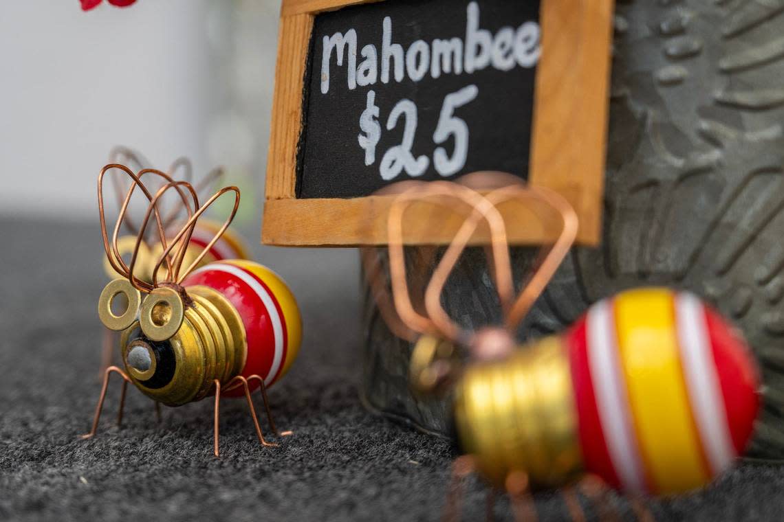 Refurbished light bulbs transformed into bumblebees, known as “Mahombee” and created by artist Annette Gordon from Paola, Kansas, are displayed at her booth Friday at the Brookside Art Annual.