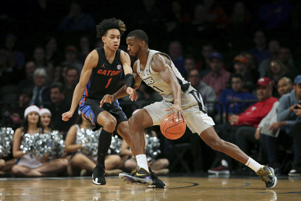 Providence guard Alpha Diallo (11) drives against Florida guard Tre Mann (1) during the first half of an NCAA college basketball game at Barclays Center, Tuesday, Dec. 17, 2019, in New York. (AP Photo/Michael Owens)