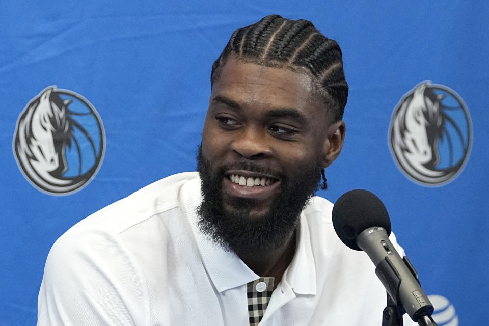 Naji Marshall smiles as he reponds to questions during an NBA basketball news conference at the team's practice facility in Dallas, Tuesday, July 9, 2024. (AP Photo/Tony Gutierrez)