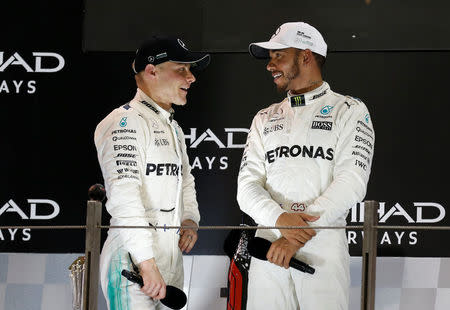 Formula One - Abu Dhabi Grand Prix - Yas Marina circuit, Abu Dhabi, United Arab Emirates - November 26, 2017 Mercedes' Lewis Hamilton and Valtteri Bottas after the race REUTERS/Ahmed Jadallah