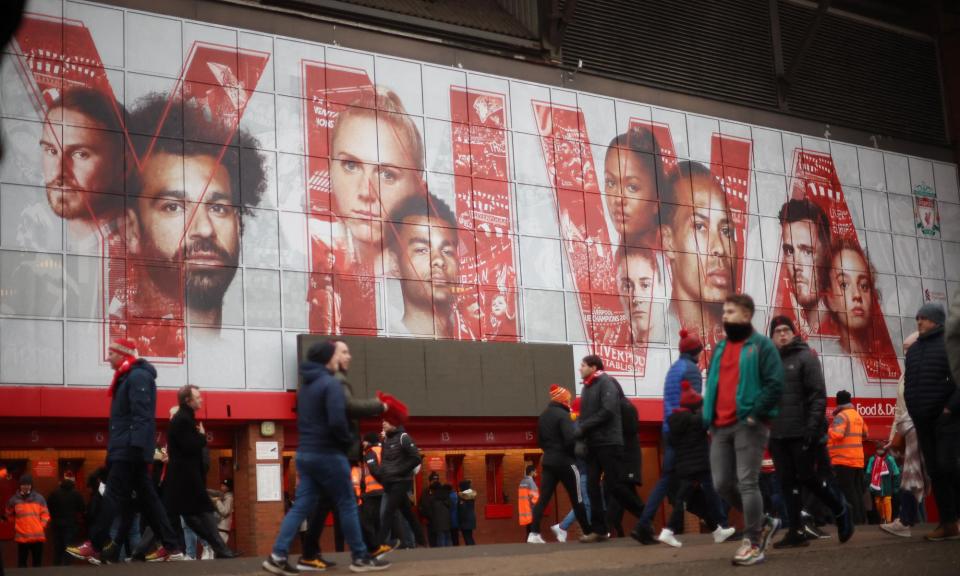 <span>Fans walk past a graphic at Anfield displaying <a class="link " href="https://sports.yahoo.com/soccer/players/3862743/" data-i13n="sec:content-canvas;subsec:anchor_text;elm:context_link" data-ylk="slk:Mohamed Salah;sec:content-canvas;subsec:anchor_text;elm:context_link;itc:0">Mohamed Salah</a>, Virgil van Dijk and <a class="link " href="https://sports.yahoo.com/soccer/players/3862746/" data-i13n="sec:content-canvas;subsec:anchor_text;elm:context_link" data-ylk="slk:Andy Robertson;sec:content-canvas;subsec:anchor_text;elm:context_link;itc:0">Andy Robertson</a> – three signings from Michael Edwards’ first spell.</span><span>Photograph: Phil Noble/Reuters</span>