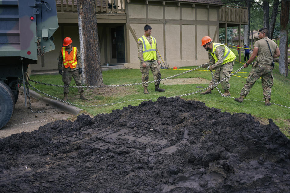 In this handout photo from the New Mexico National Guard, members of the New Mexico National guard work on flooding damage Saturday, June 29, 2024, in Ruidoso, N.M. Thunderstorms are hopscotching around the Southwestern U.S., bringing much-needed moisture to a region where every drop counts. (Spc. Jose Montoya/New Mexico National Guard via AP)