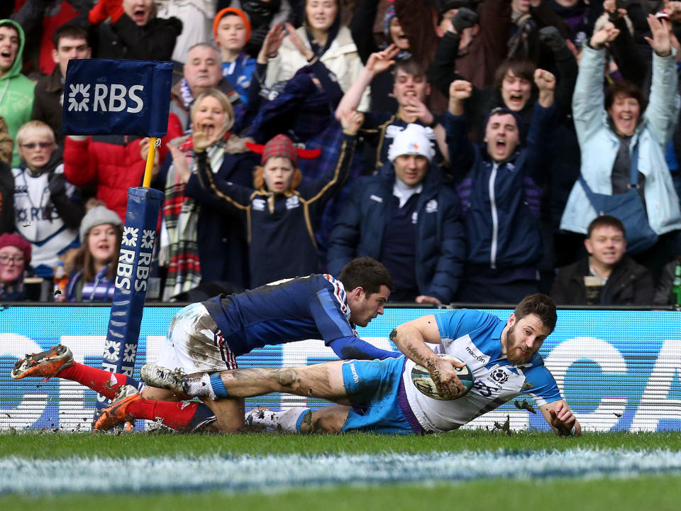 Scotland's Tommy Seymour, right, scores his try ahead of France's Brice Dulin, left, during their Six Nations rugby union international match at Murrayfield in Edinburgh, Scotland, Saturday March 8, 2014. (AP Photo/Scott Heppell)