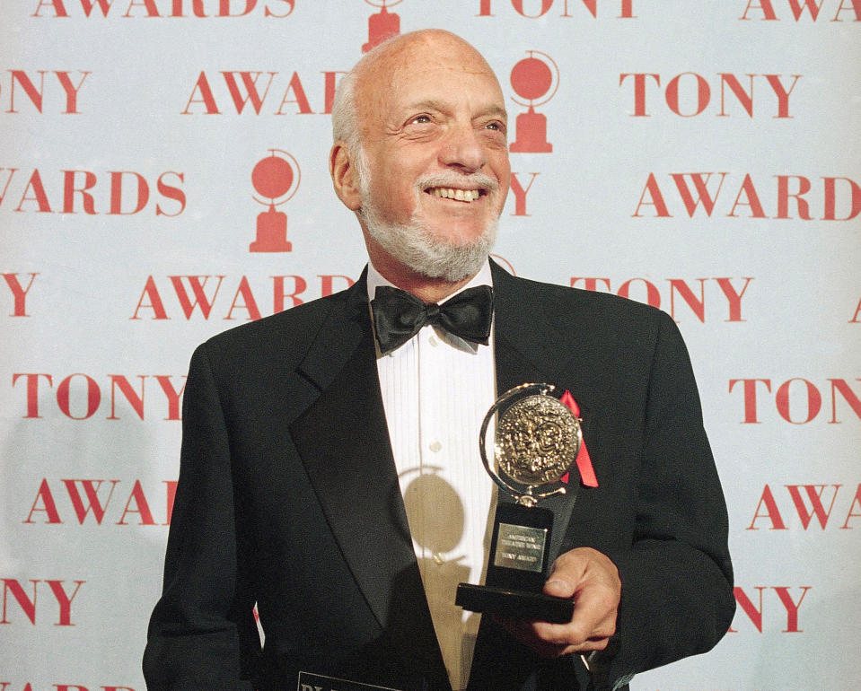 FILE - In this June 4, 1995 file photo, Harold Prince holds his Tony award for best director in a musical for "Show Boat," at Broadway's Minskoff Theater in New York. Prince, who pushed the boundaries of musical theater with such groundbreaking shows as “The Phantom of the Oepra,” "Cabaret," "Company" and "Sweeney Todd" and won a staggering 21 Tony Awards, died Wednesday, July 31, 2019, after a brief illness in Reykjavik, Iceland. He was 91. (AP Photo/Richard Drew, File)