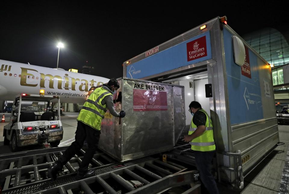 A Pfizer-BioNTech COVID-19 coronavirus vaccine shipment is offloaded from an Emirates Airlines Boing 777 that arrived from Brussels to Dubai International Airport in Dubai, United Arab Emirates, early Sunday, Feb. 21, 2021. As the coronavirus pandemic continues to clobber the aviation industry, Emirates Airlines, the Middle East’s biggest airline, is seeking to play a vital role in the global vaccine delivery effort. (AP Photo/Kamran Jebreili)