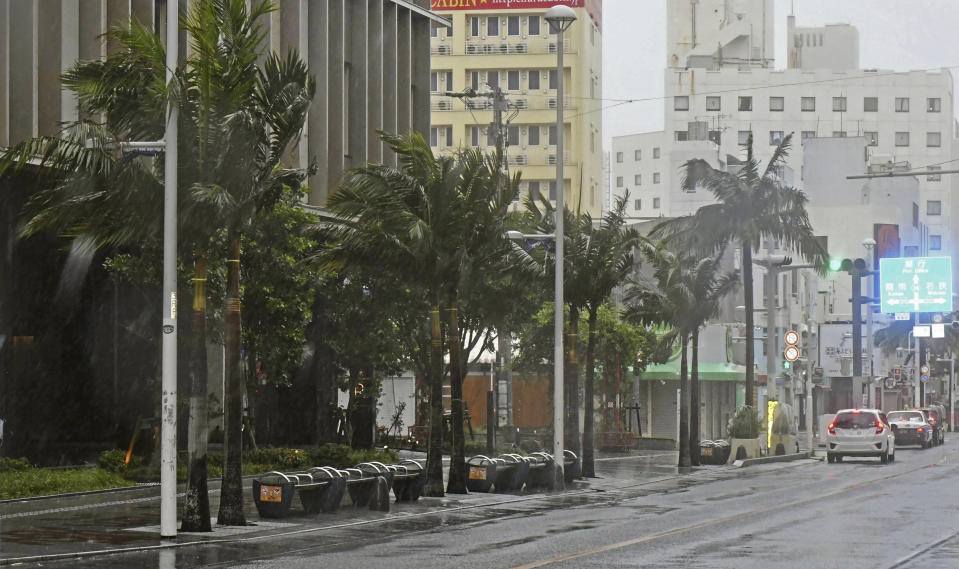 A main street is deserted as Typhoon Khanun approaches Naha city, Okinawa prefecture, southern Japan, Saturday, Aug. 5, 2023. Residents of Japan's southwestern islands were warned of high winds and rain Friday through the weekend as Typhoon Khanun made a U-turn and is now moving back east. (Kyodo News via AP)