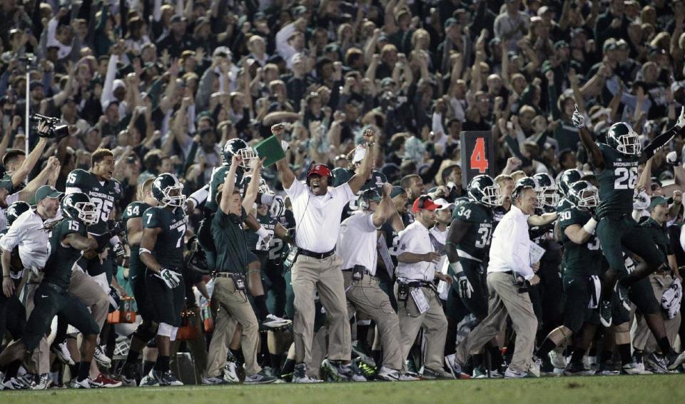 Michigan State players, coaches and fans react to a play during the second half of the Rose Bowl NCAA college football game against Stanford on Wednesday, Jan. 1, 2014, in Pasadena, Calif. Michigan State won 24-20. (AP Photo/Jae C. Hong)